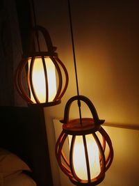 Close-up of illuminated lamp hanging on wall