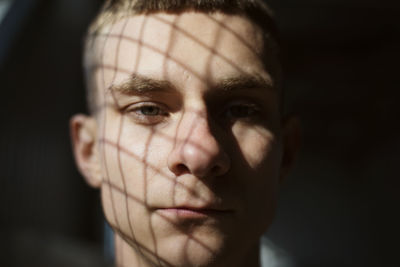 Close-up portrait of man with shadow