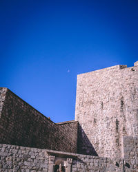 Low angle view of building against blue sky