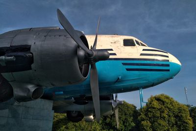 Low angle view of airplane flying against sky