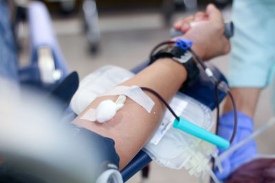 Cropped image of man donating blood in hospital
