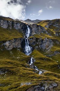 Scenic view of waterfall against sky