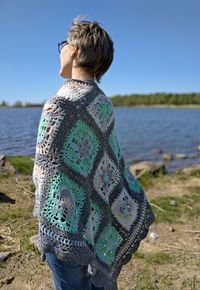 Rear view of woman looking at sea shore against sky