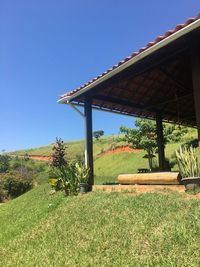 Gazebo by trees against clear sky