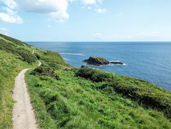 Scenic view of sea and coast against sky