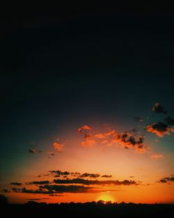 Scenic view of silhouette landscape against sky at sunset