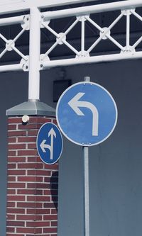 Road sign against blue sky