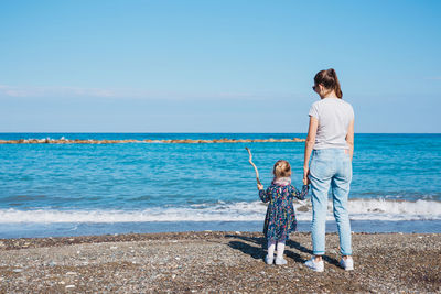 Full length of woman standing at beach