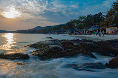 View of beach against cloudy sky