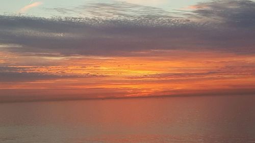 Scenic view of sea against sky at sunset