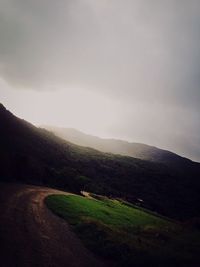 Scenic view of landscape against cloudy sky