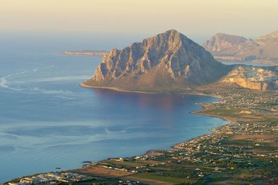 Scenic view of sea and mountains against sky