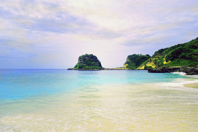 Scenic view of sea against cloudy sky