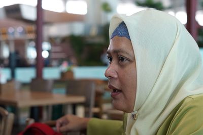 Close-up of mature woman wearing hijab at restaurant