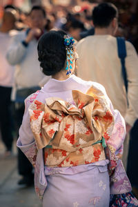 Rear view of people standing outdoors