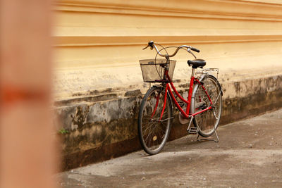 Bicycle leaning against wall