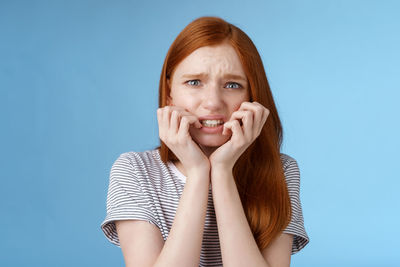 Portrait of woman against blue background