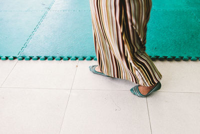 Low section of woman walking on floor