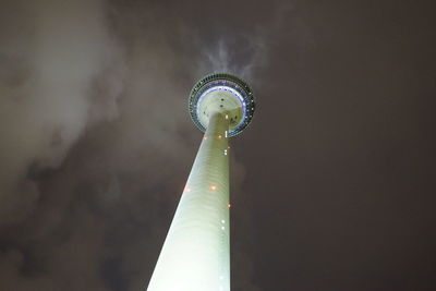 Low angle view of illuminated tower against sky