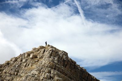 Low angle view of rock formation on mountain against sky