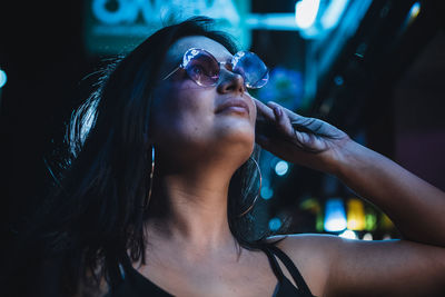 Midsection of woman drinking water from sunglasses