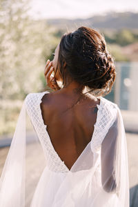 Rear view of bride standing outdoors