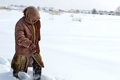 Man standing on snow covered field