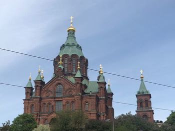 Low angle view of church against sky in city