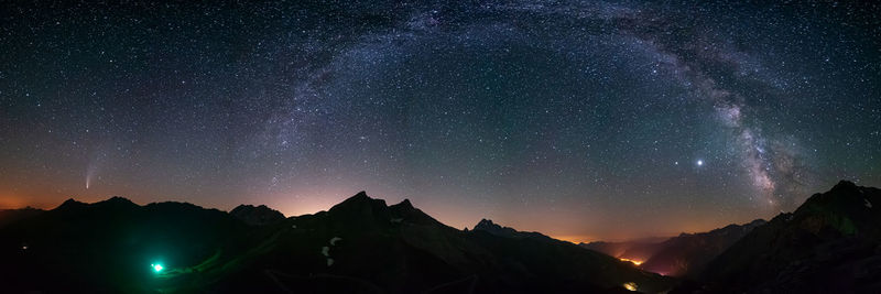 Scenic view of mountains against sky at night