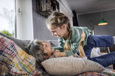 Mother and daughter while sitting on floor