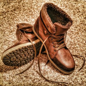 Close-up of shoes on tiled floor