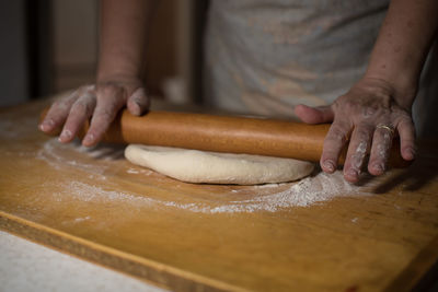 Midsection of person preparing food on table
