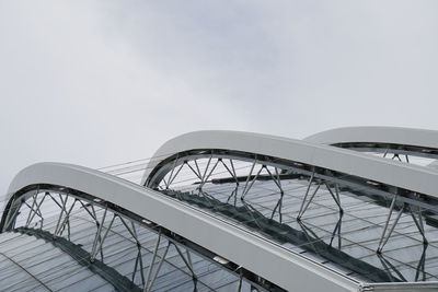 Low angle view of modern bridge against sky