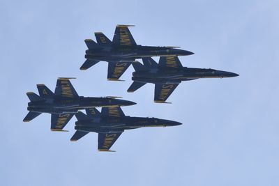 Low angle view of airplane flying against sky