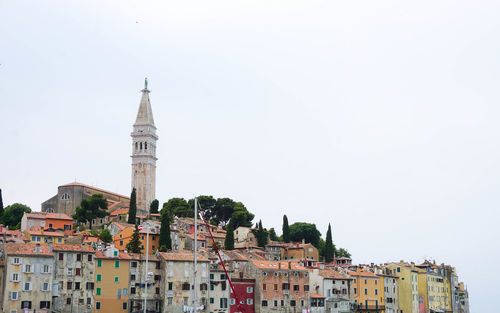 Buildings in city against clear sky