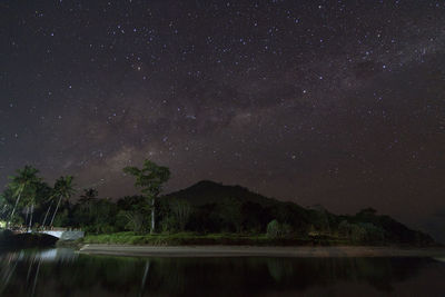 Scenic view of lake against star field at night