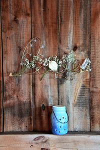 Close-up of jar hanging on wood