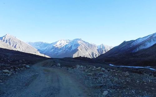 Scenic view of snowcapped mountains against clear blue sky