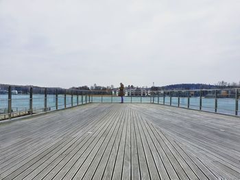 View of pier on bridge over river against sky