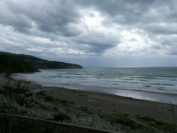 Scenic view of sea against storm clouds