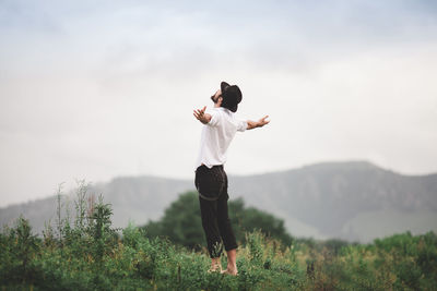 Full length of man standing on field against sky