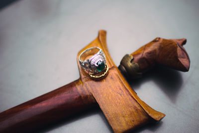 High angle view of wedding rings on walking cane