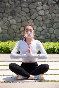 Beautiful chinese girl wearing n95 face mask while working out