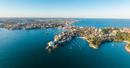 High angle view of sea and city against sky