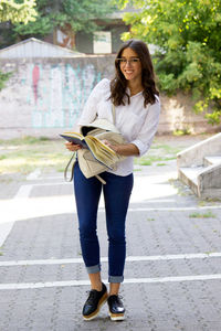 Full length portrait of a smiling young woman