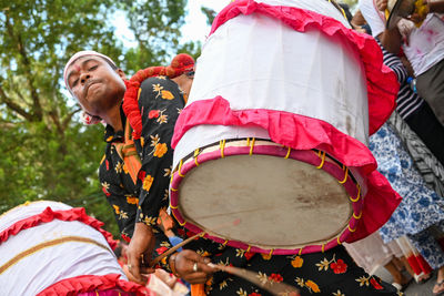 Rear view of woman holding umbrella