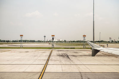 Empty street at airport against sky