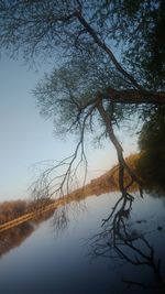 Scenic view of lake against sky at sunset