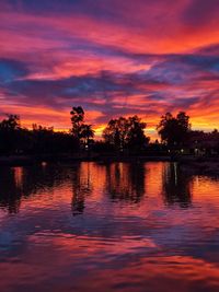 Scenic view of lake against romantic sky at sunset