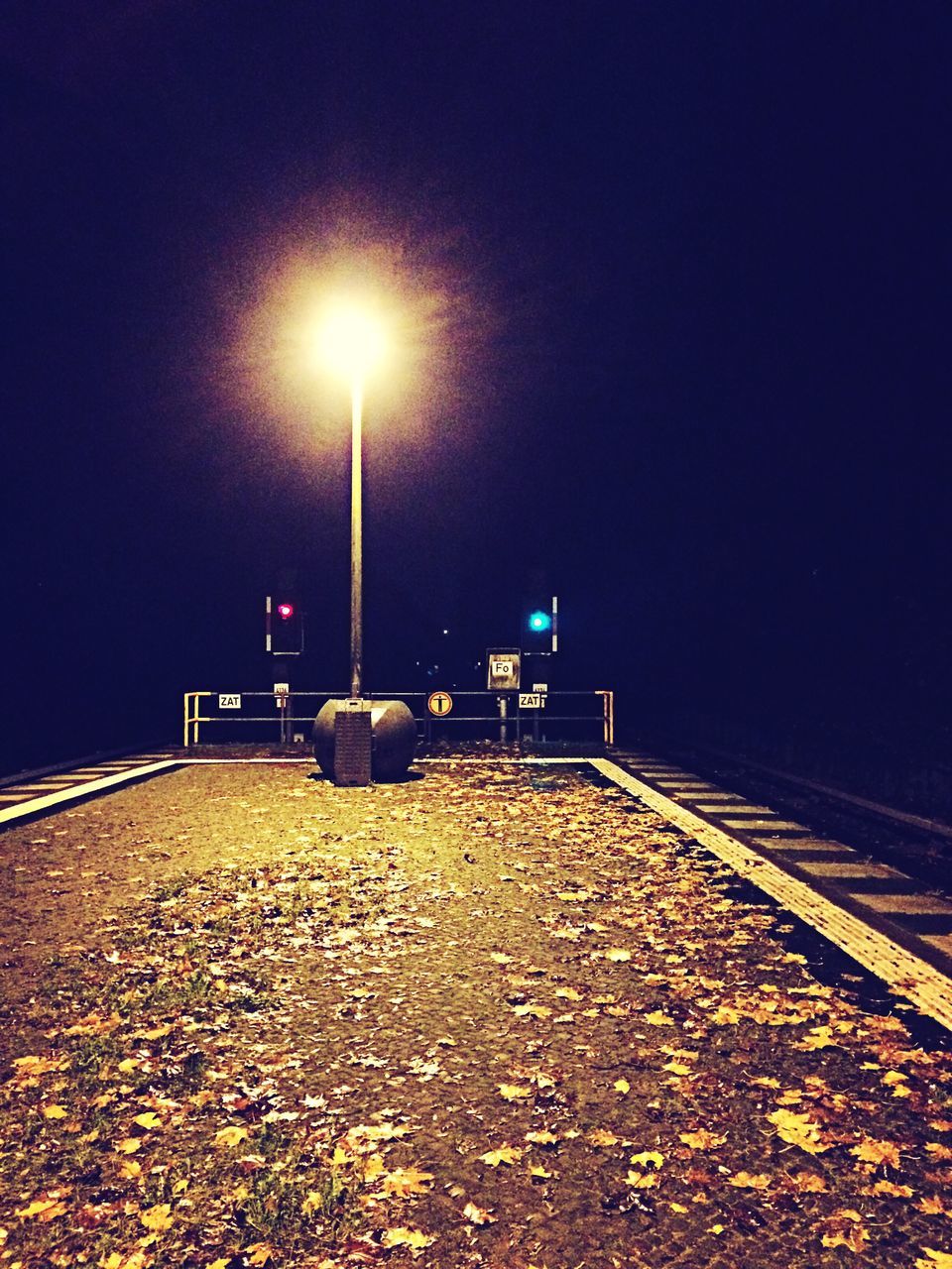 illuminated, night, street light, lighting equipment, the way forward, transportation, clear sky, road, outdoors, empty, street, copy space, railing, nature, sky, no people, absence, diminishing perspective, tranquility, built structure